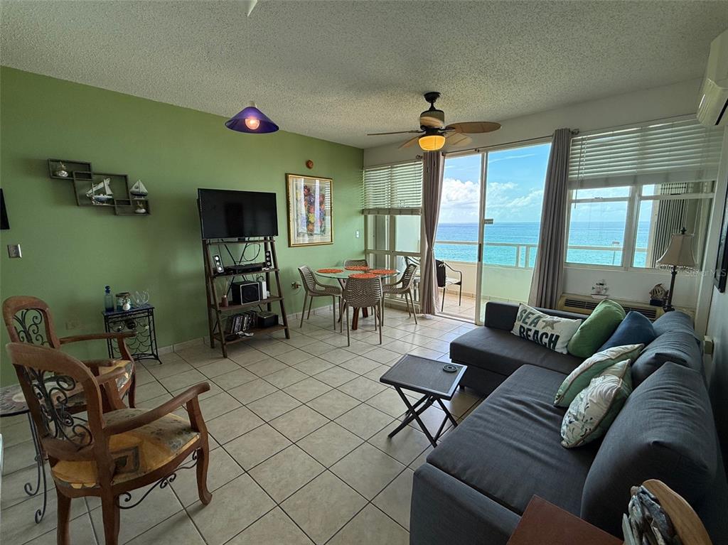 Condo Pelican Reef Condo Pelican Reef, Unit 302 Rincon, PR 00677 - Photo 4 of 16 a living room with furniture and a flat screen tv