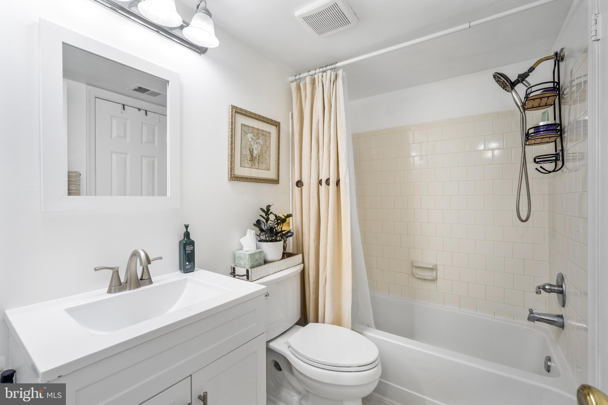 107 Fort Evans Road Southeast, Unit B Leesburg, VA 20176 - Photo 11 of 21 a bathroom with a sink toilet vanity and shower