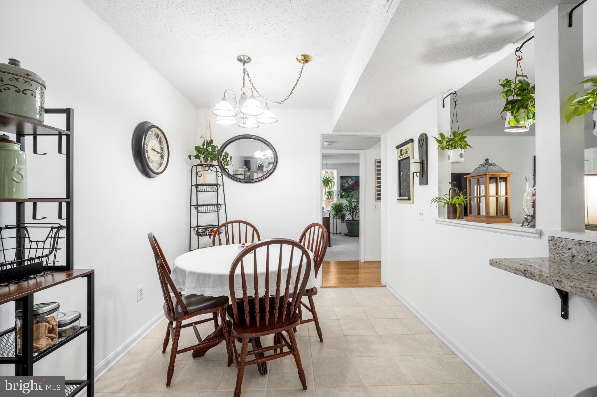 107 Fort Evans Road Southeast, Unit B Leesburg, VA 20176 - Photo 13 of 21 a view of a dining room with furniture clock and wooden floor