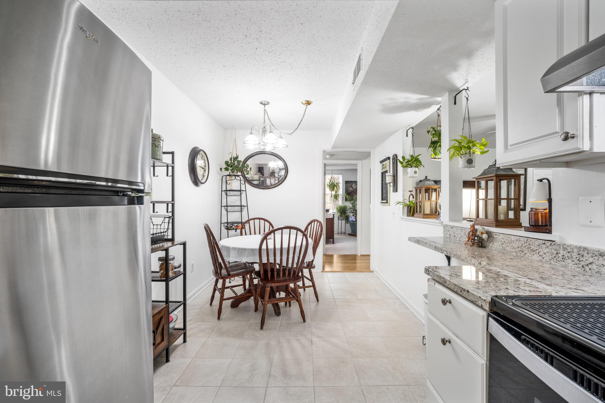 107 Fort Evans Road Southeast, Unit B Leesburg, VA 20176 - Photo 14 of 21 a view of a kitchen and dining area with chandelier