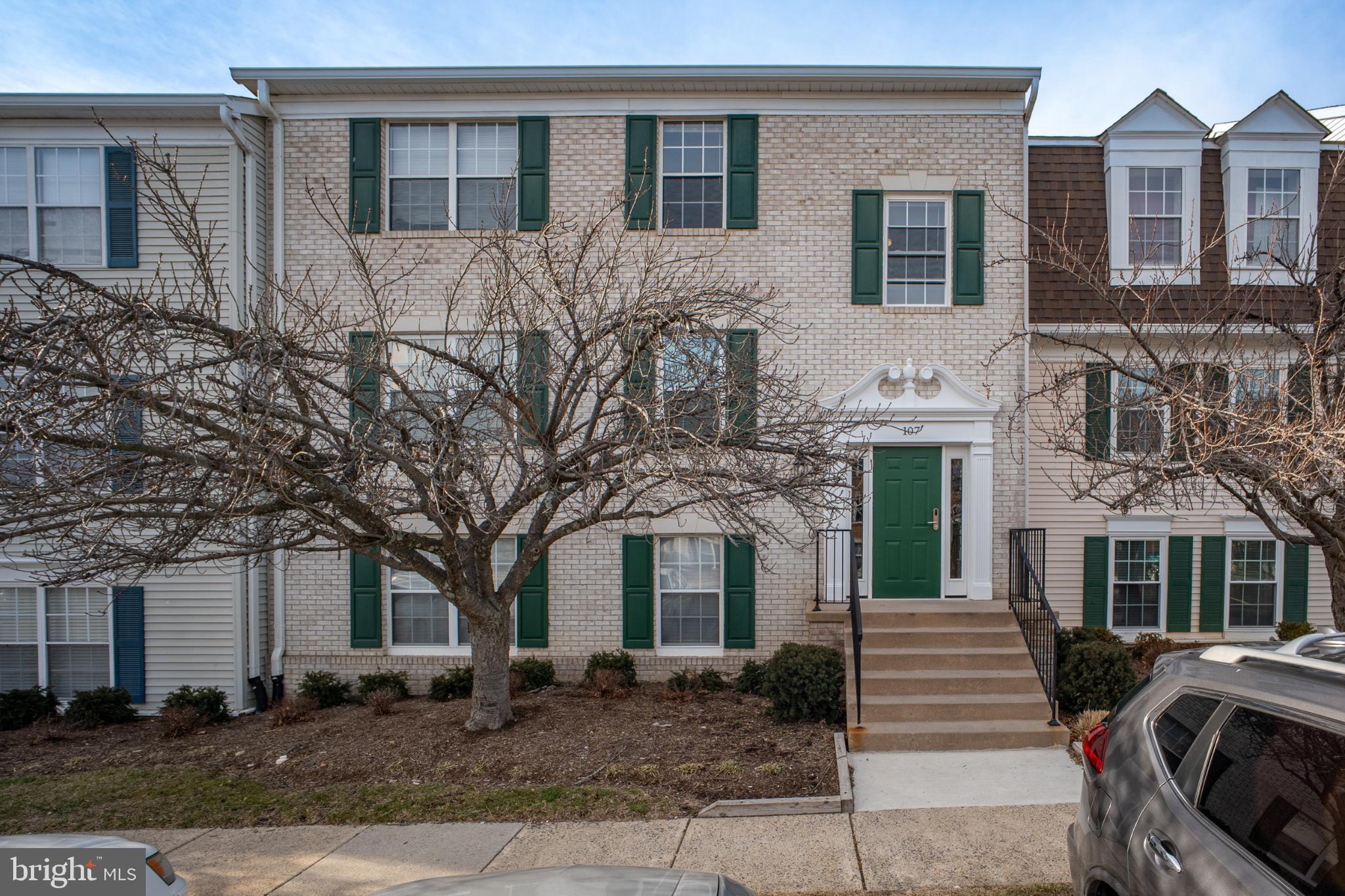 107 Fort Evans Road Southeast, Unit B Leesburg, VA 20176 - Photo 20 of 21 a front view of a house with garden