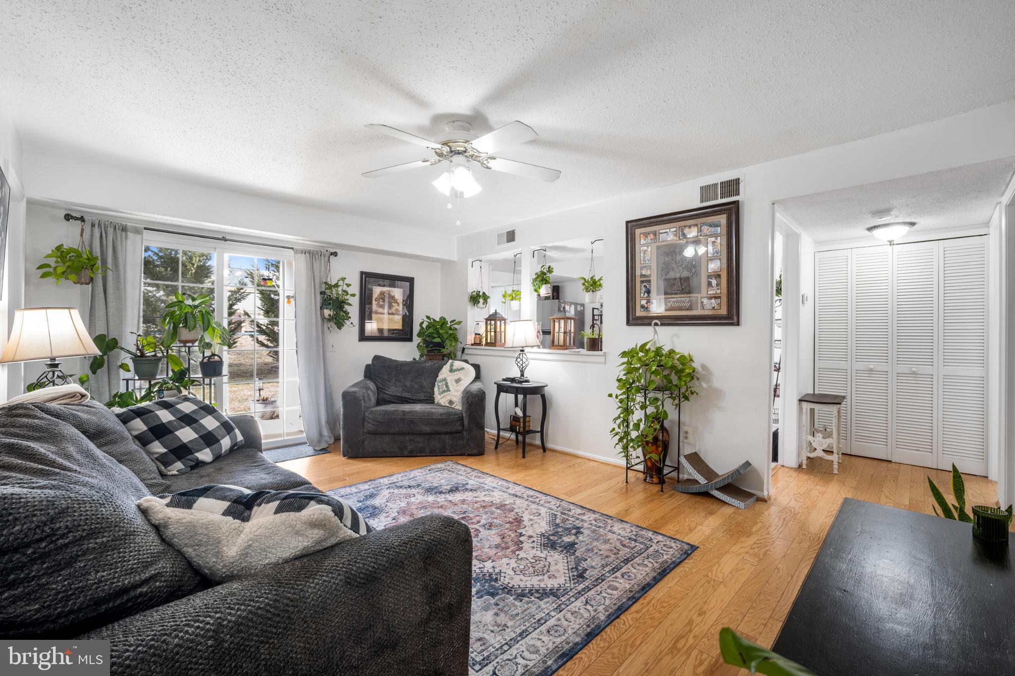 107 Fort Evans Road Southeast, Unit B Leesburg, VA 20176 - Photo 2 of 21 a living room with furniture and a wooden floor