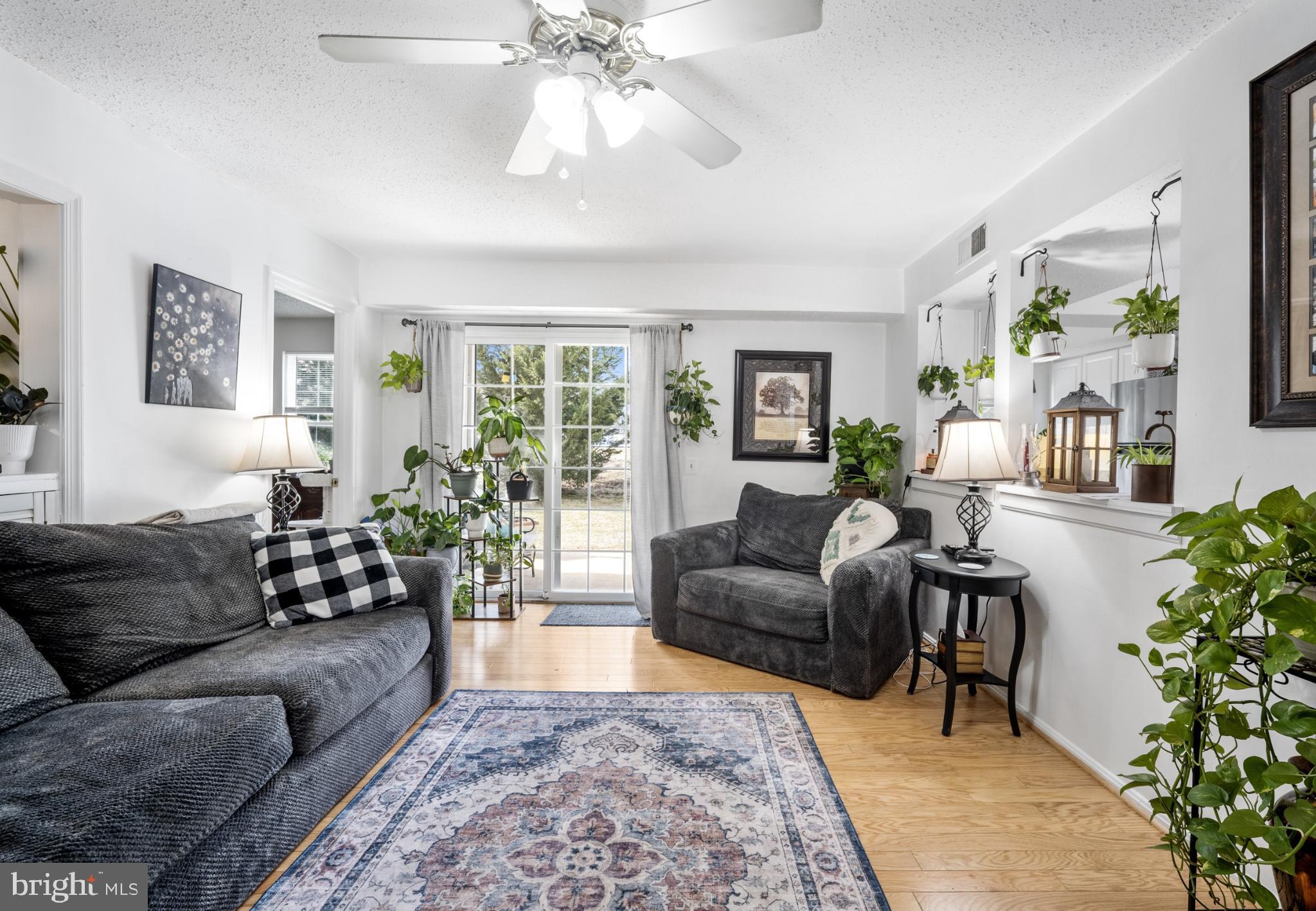 107 Fort Evans Road Southeast, Unit B Leesburg, VA 20176 - Photo 3 of 21 a living room with furniture and a large window