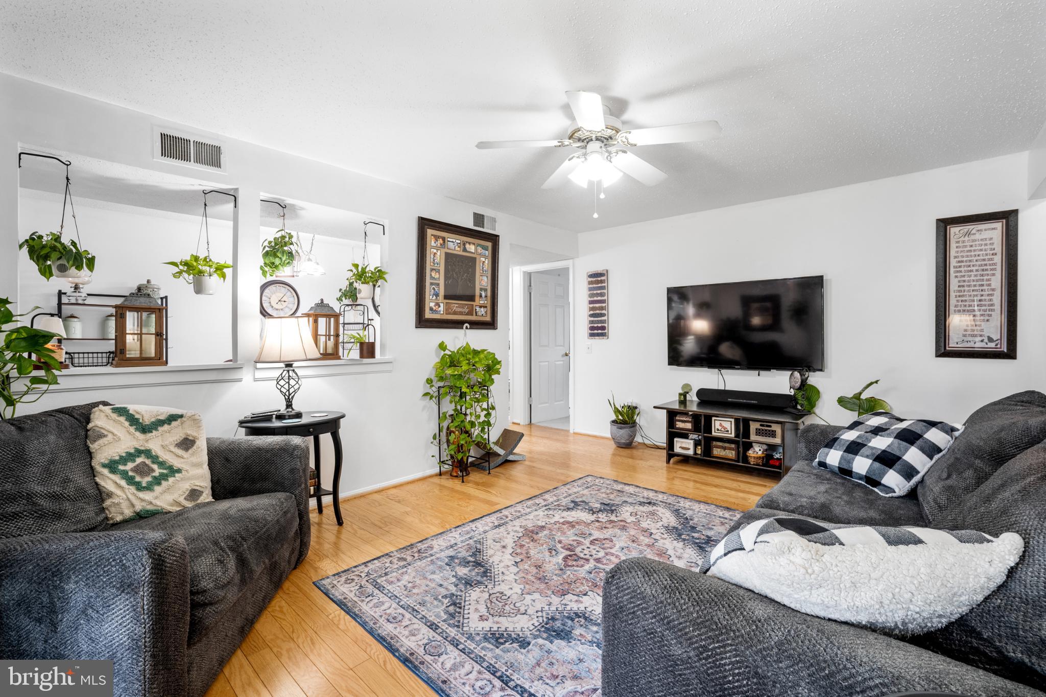 107 Fort Evans Road Southeast, Unit B Leesburg, VA 20176 - Photo 5 of 21 a living room with furniture and a flat screen tv