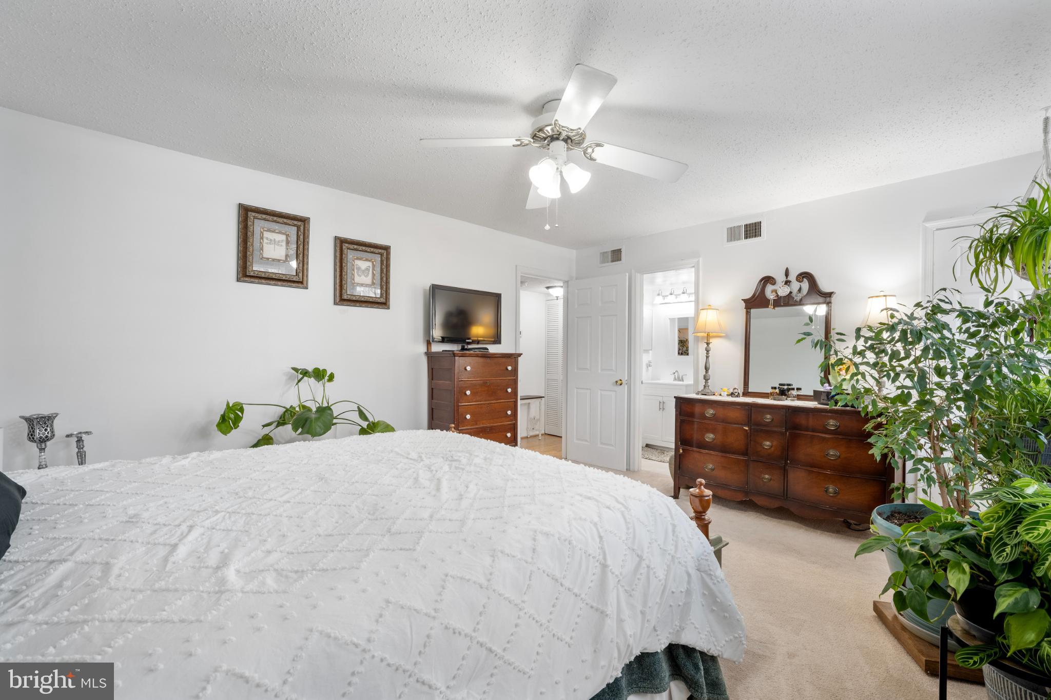 107 Fort Evans Road Southeast, Unit B Leesburg, VA 20176 - Photo 8 of 21 a bedroom with a bed and a chandelier