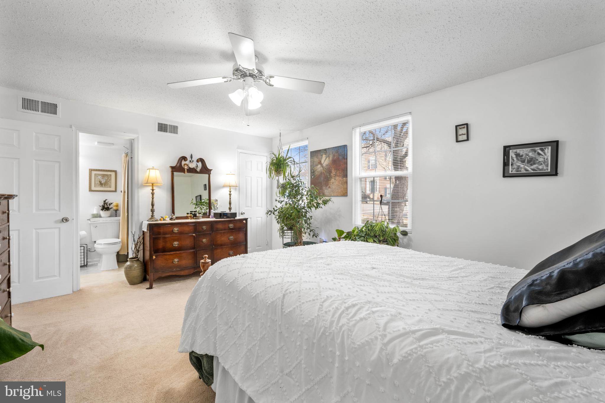 107 Fort Evans Road Southeast, Unit B Leesburg, VA 20176 - Photo 9 of 21 a bedroom with a bed and a chandelier