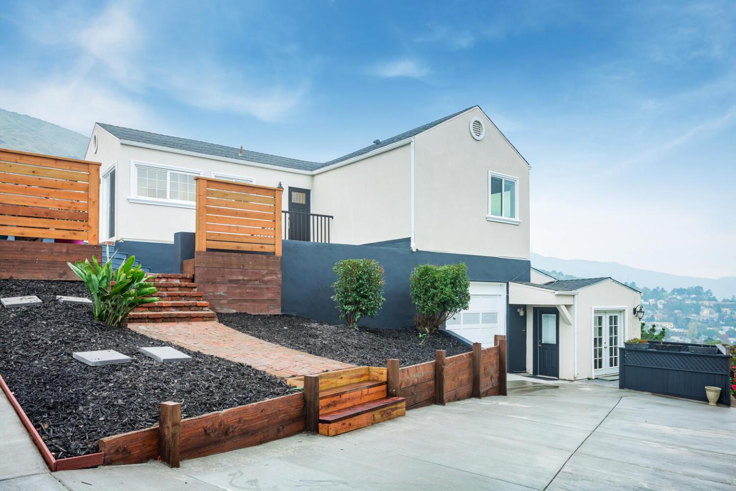 1100 Humboldt Road Brisbane, CA 94005 - Photo 1 of 37 a front view of a house with garden