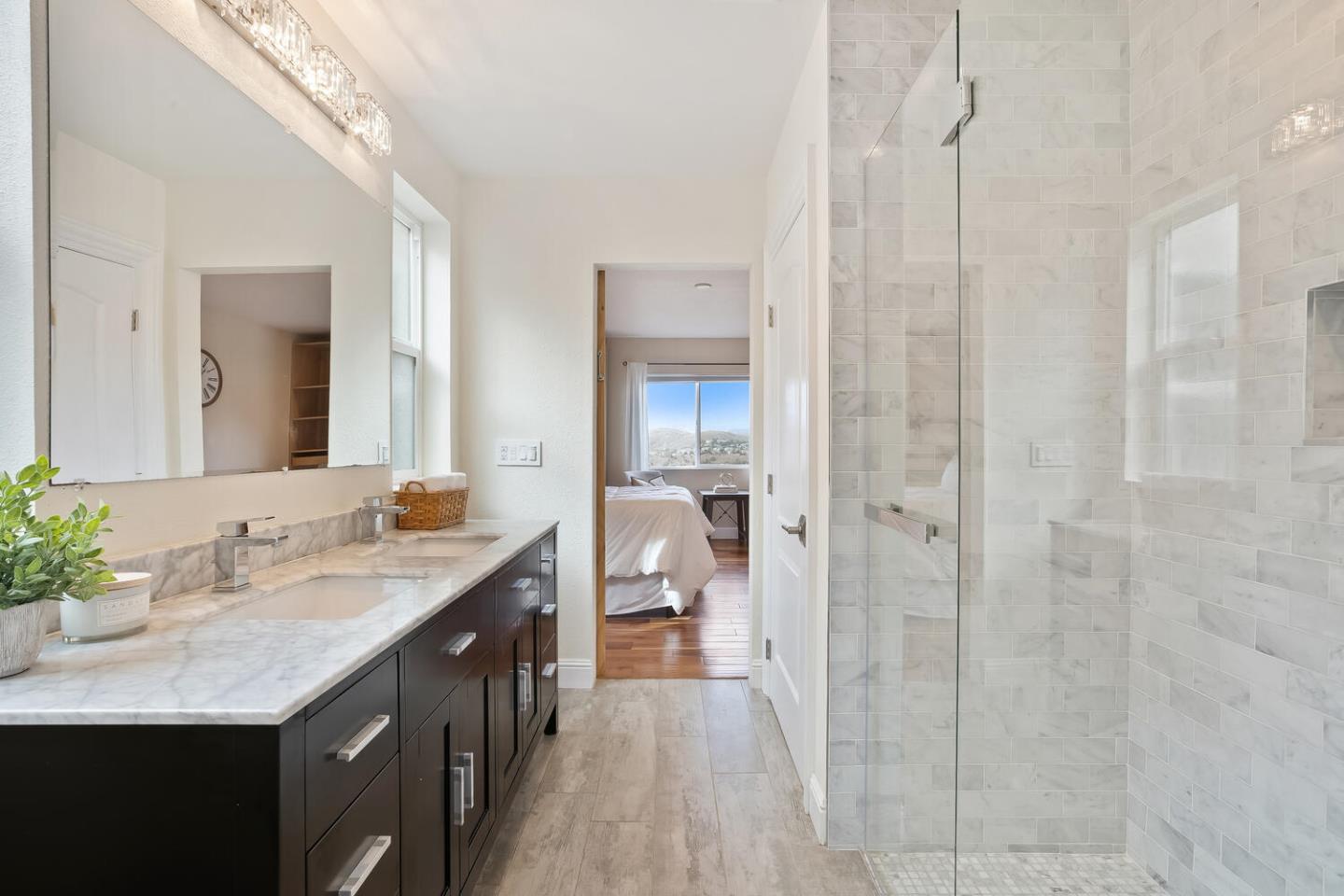 1100 Humboldt Road Brisbane, CA 94005 - Photo 18 of 37 a en suite bathroom with a sink a mirror and a shower