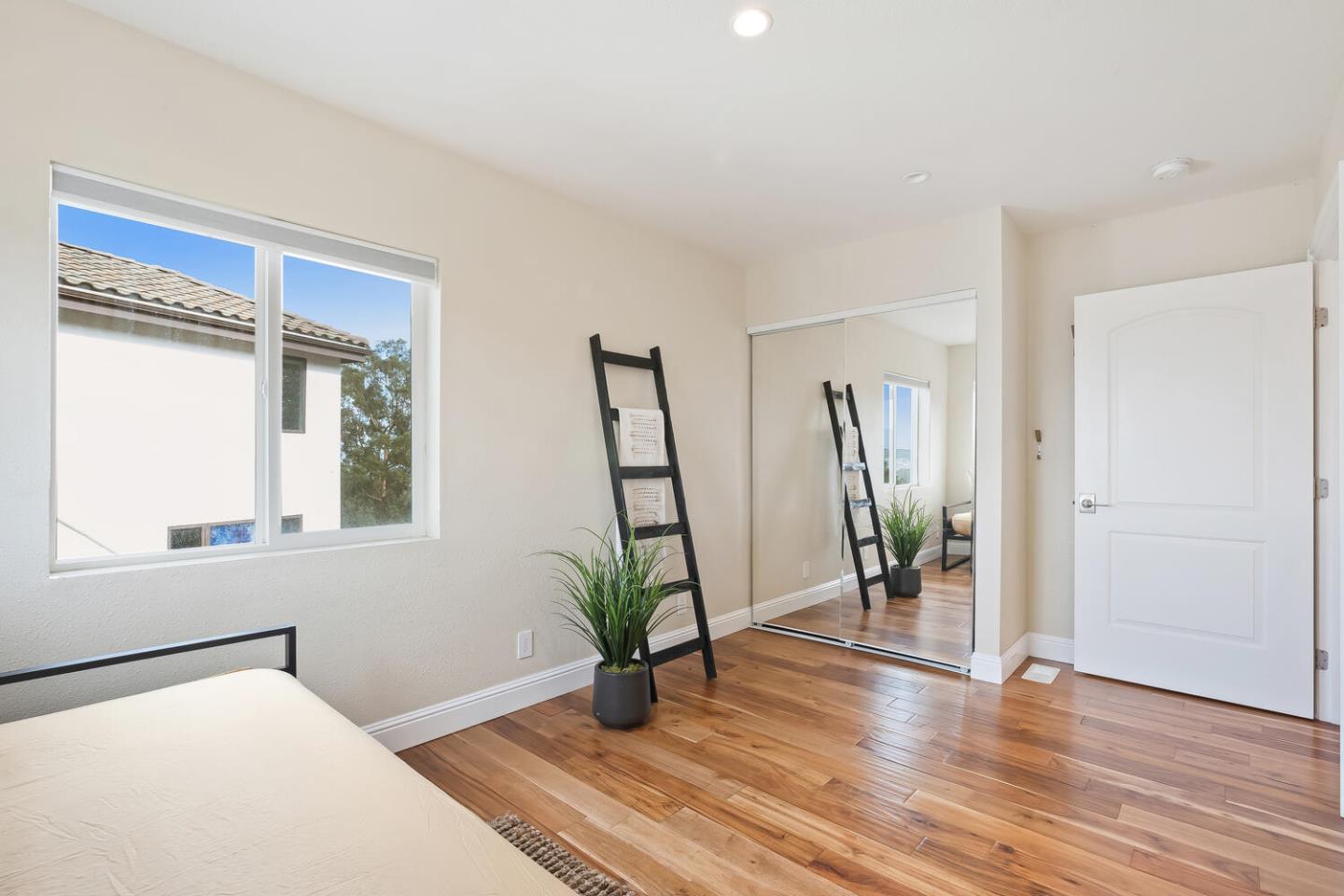 1100 Humboldt Road Brisbane, CA 94005 - Photo 22 of 37 a bedroom with furniture and a potted plant