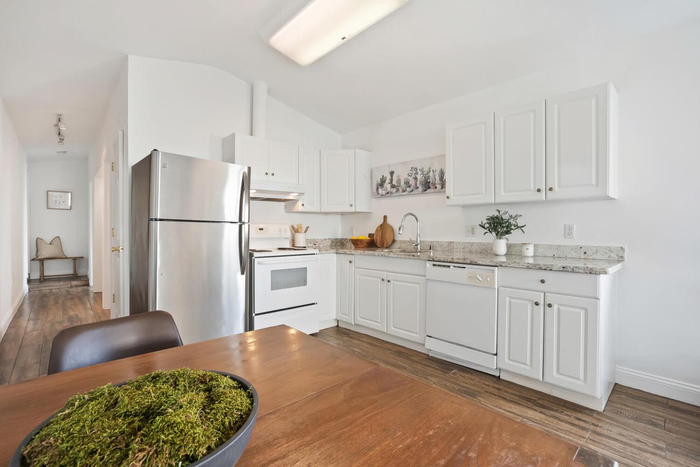 1100 Humboldt Road Brisbane, CA 94005 - Photo 29 of 37 a kitchen with a refrigerator white cabinets and a sink