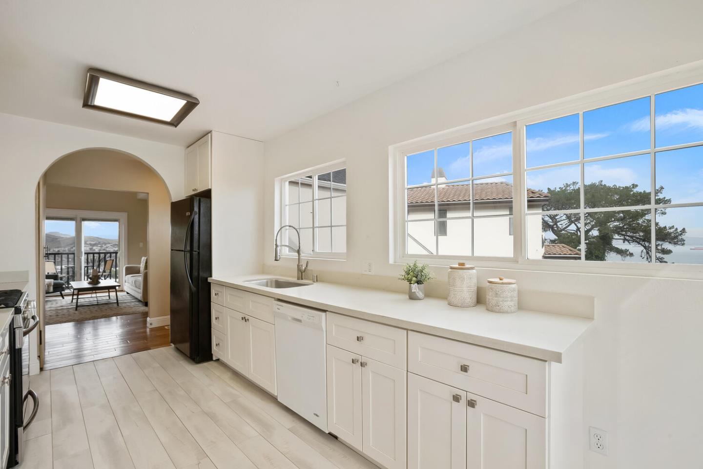 1100 Humboldt Road Brisbane, CA 94005 - Photo 10 of 37 a hall with a sink cabinets and wooden floor