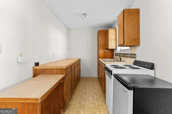 a utility room with a sink dryer and washer