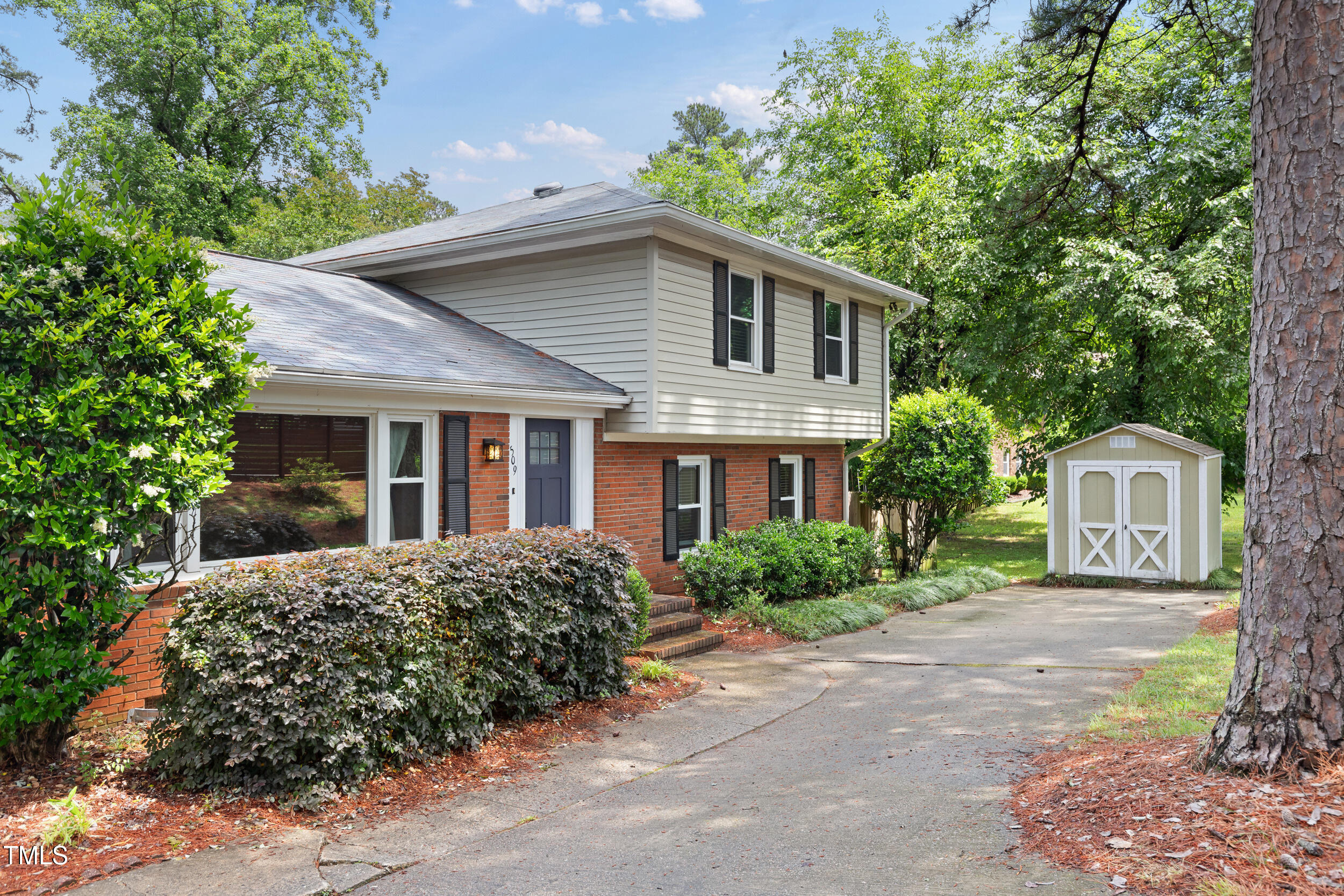 509 East Millbrook Road Raleigh, NC 27609 - Photo 3 of 51 a front view of a house with a garden