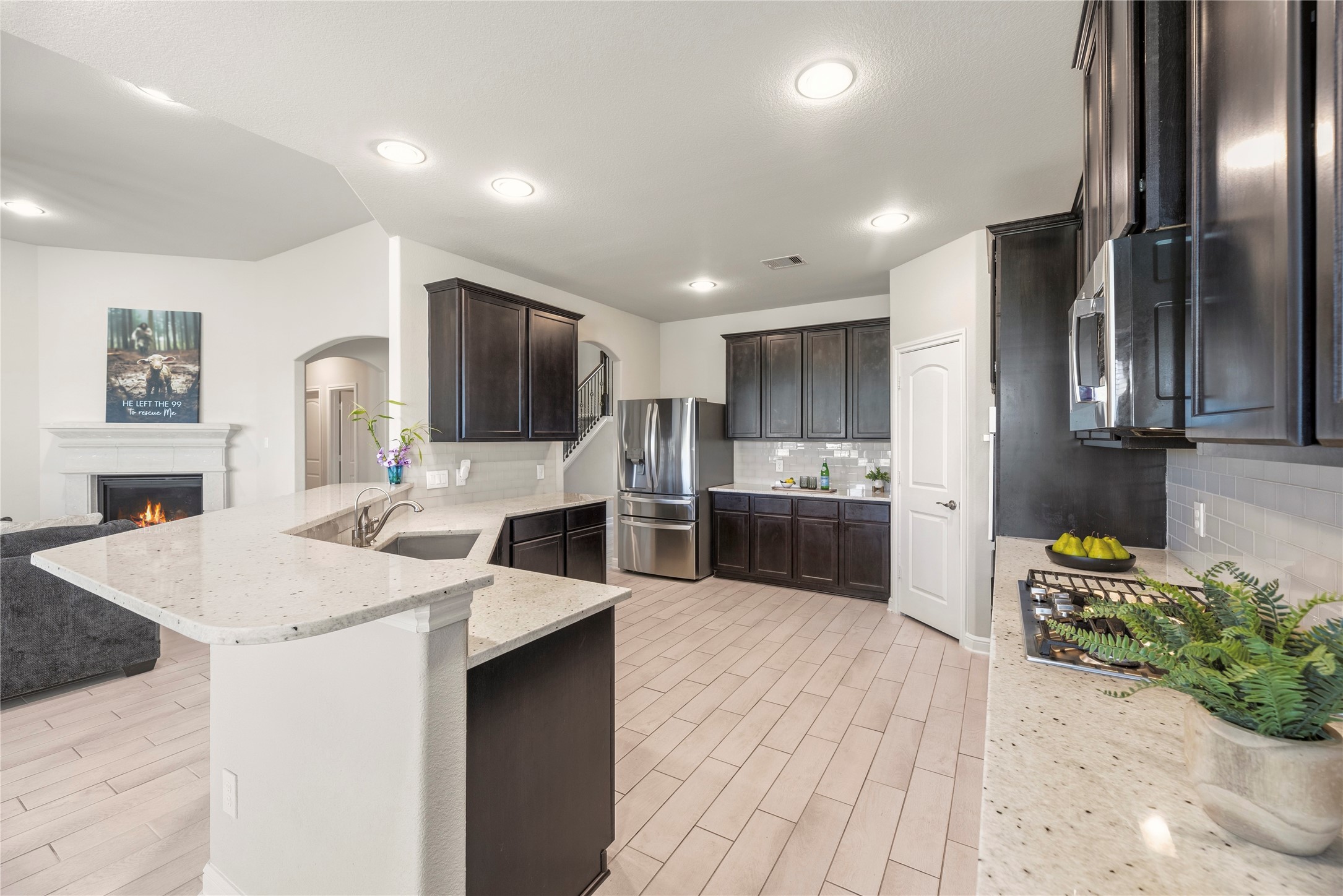 3319 Learning Tree Lane Rosenberg, TX 77471 - Photo 6 of 44 a large kitchen with stainless steel appliances kitchen island a large counter top a stove and a sink