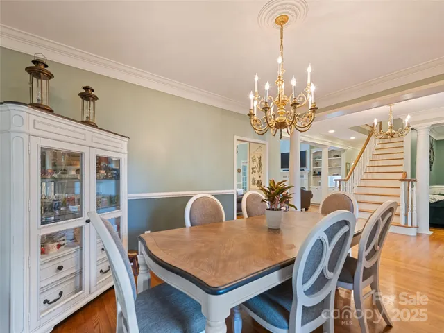 a view of a dining room with furniture and chandelier