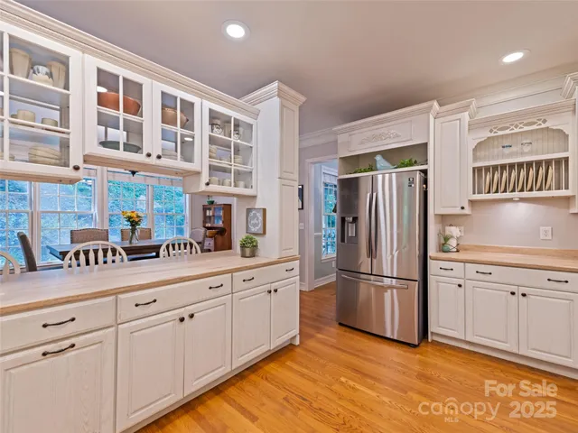 a kitchen with stainless steel appliances granite countertop a refrigerator and a sink