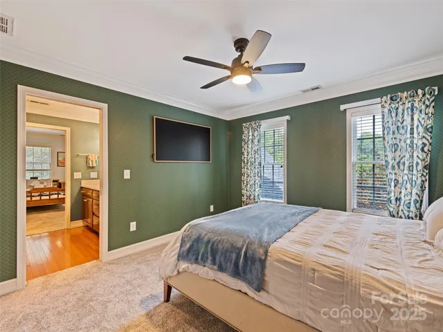 a bedroom with a large bed and a chandelier