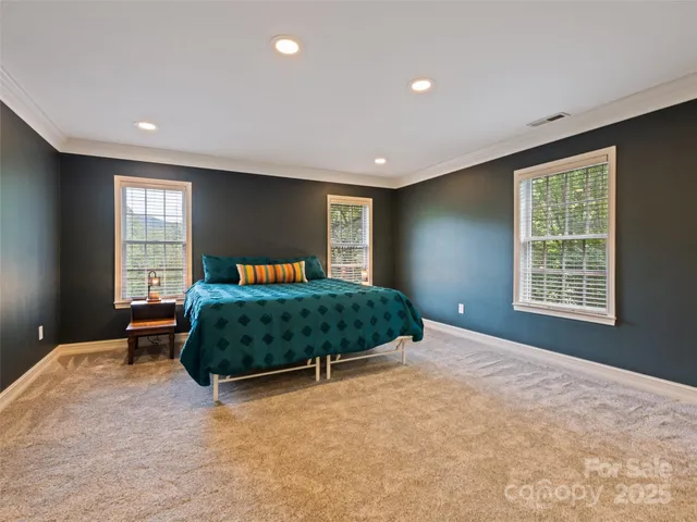 a bedroom with a large bed and a large window