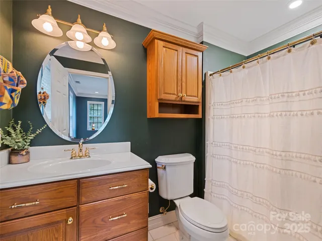 a bathroom with a toilet a sink and a mirror