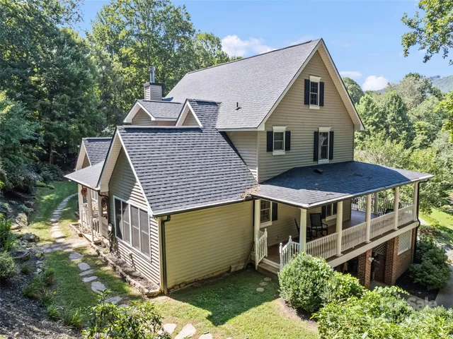 a aerial view of a house with a yard and plants