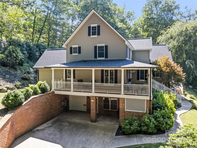 a front view of a house with a yard garage and outdoor seating