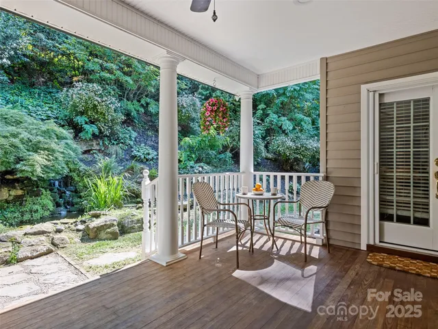 a view of a two chairs and table in the balcony