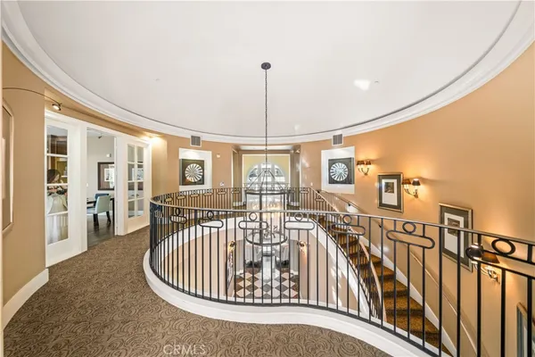 a view of a hallway with furniture and a window