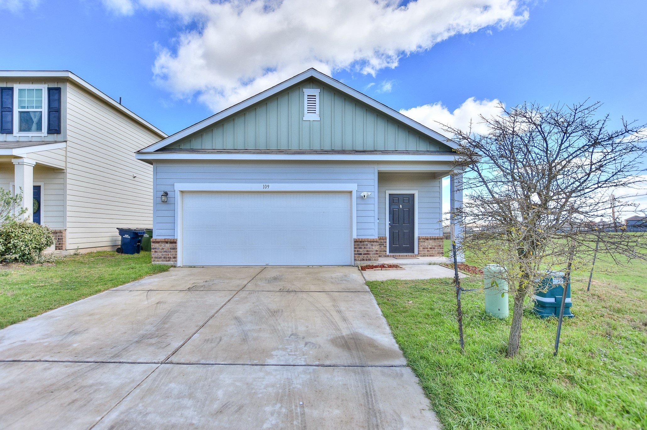 109 Helios Drive Jarrell, TX 76537 - Photo 3 of 36 a front view of a house with a yard and garage