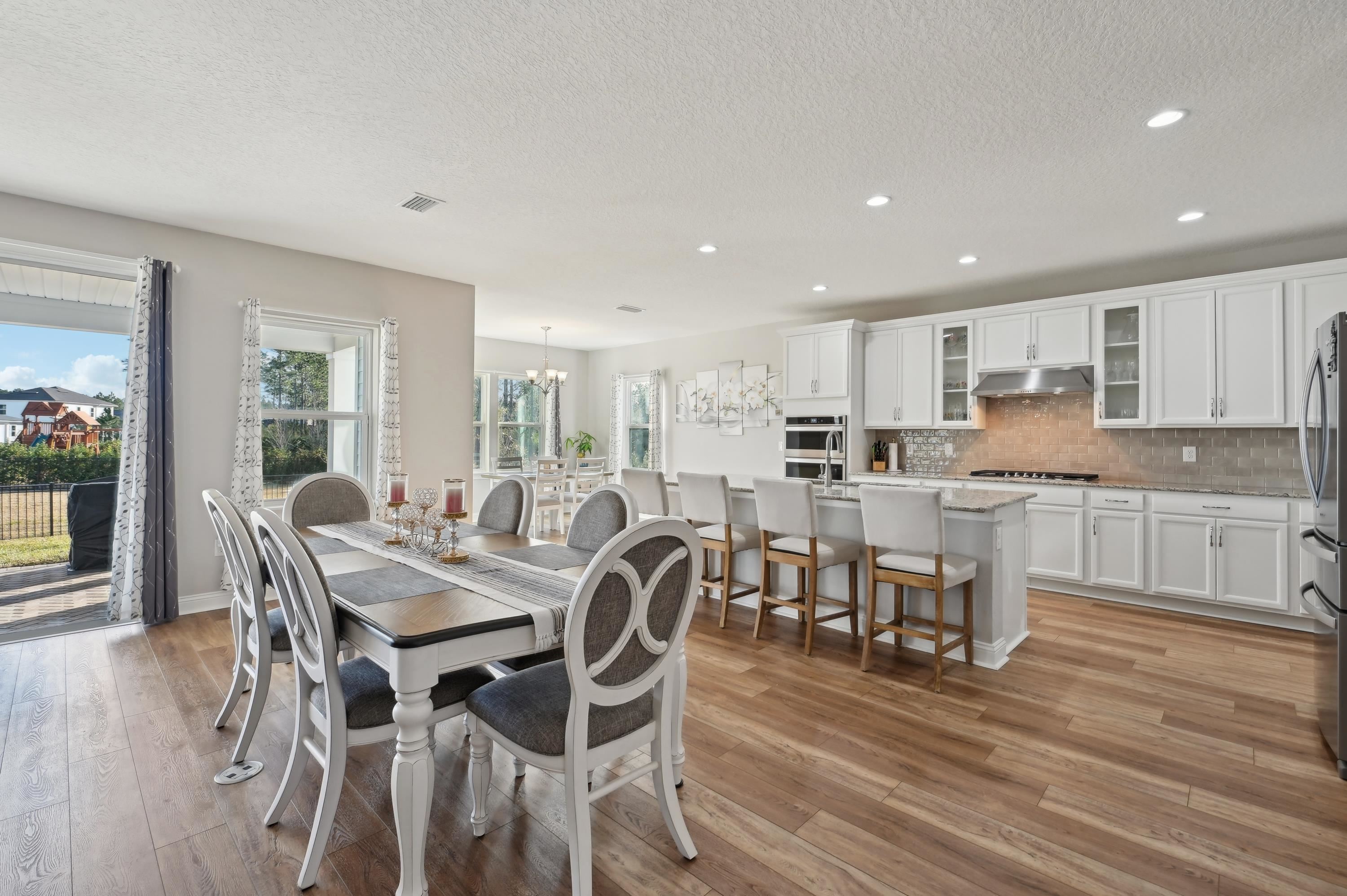 57 Sunset Ridge Court St. Johns, FL 32259 - Photo 14 of 79 a view of a dining room with furniture wooden floor and kitchen view