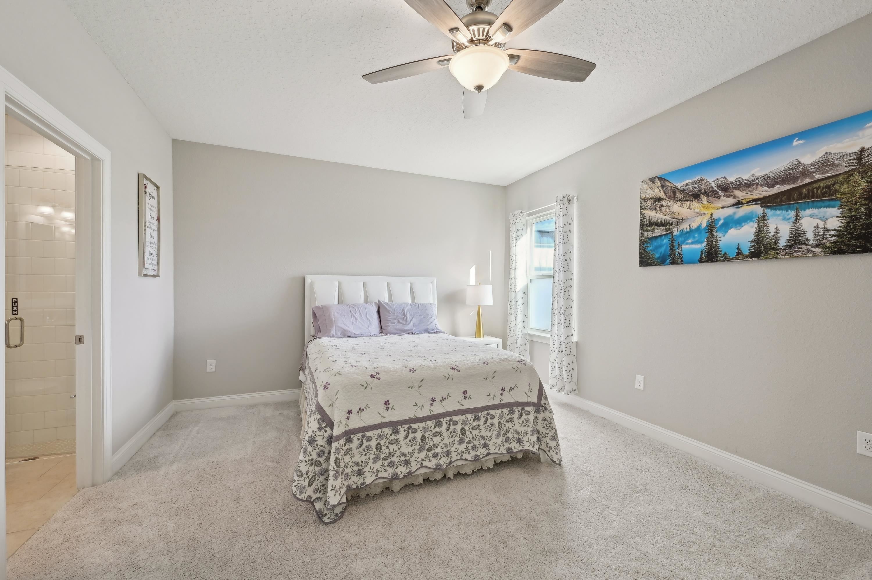 57 Sunset Ridge Court St. Johns, FL 32259 - Photo 25 of 79 a bedroom with a bed and a chandelier