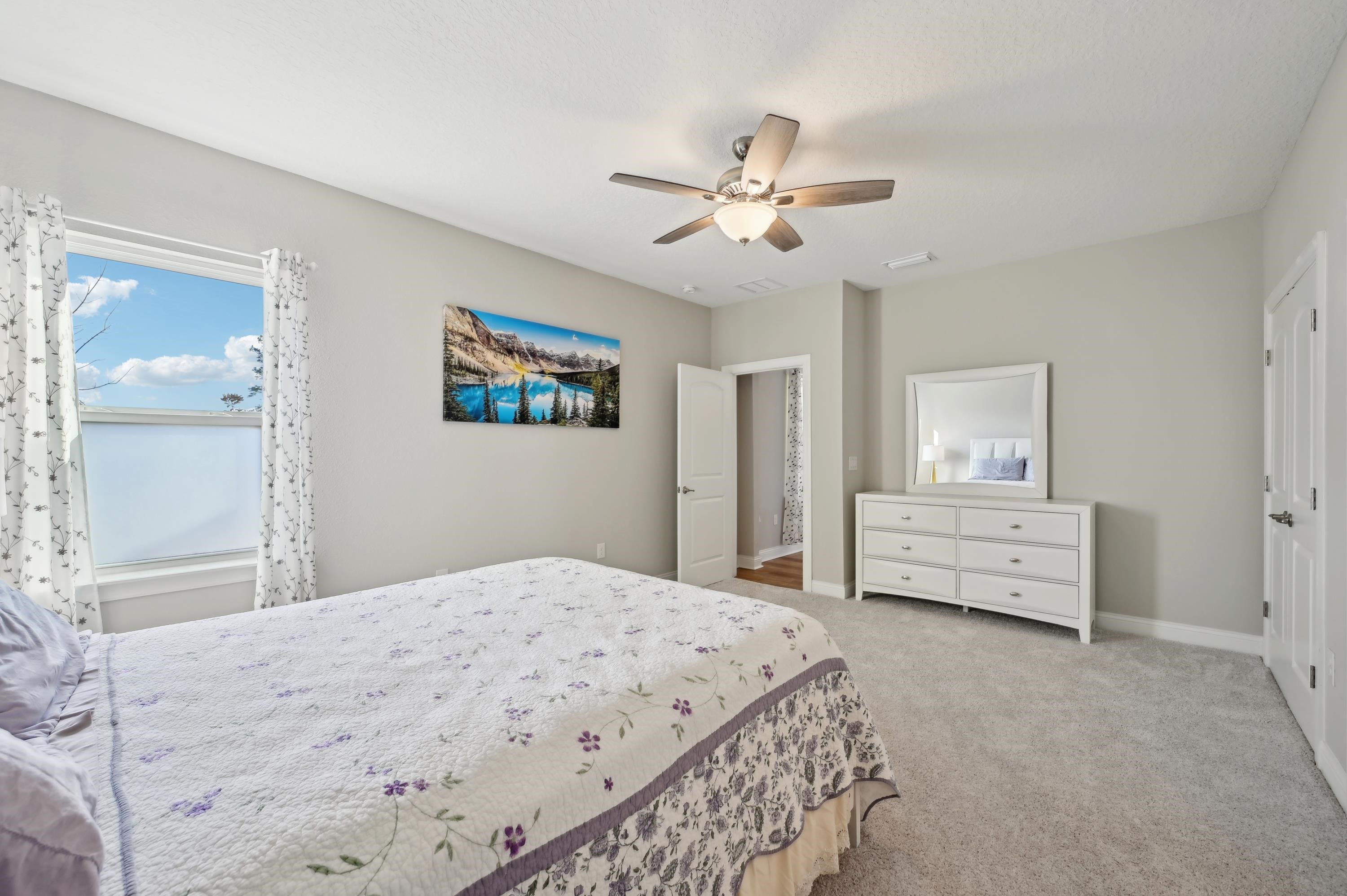 57 Sunset Ridge Court St. Johns, FL 32259 - Photo 26 of 79 a bedroom with a bed and a chandelier