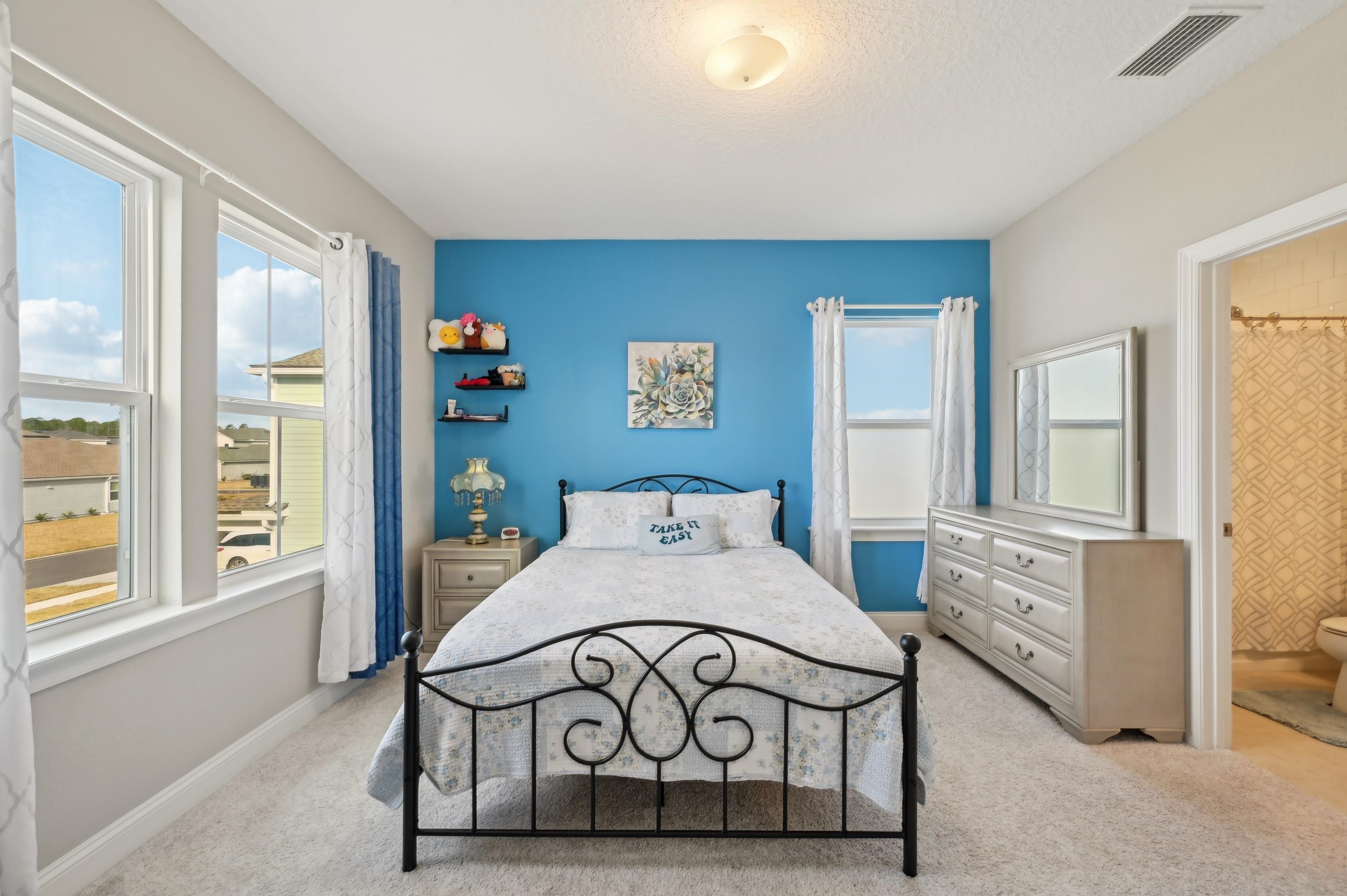 57 Sunset Ridge Court St. Johns, FL 32259 - Photo 41 of 79 a bedroom with a bed a table and painting on the wall