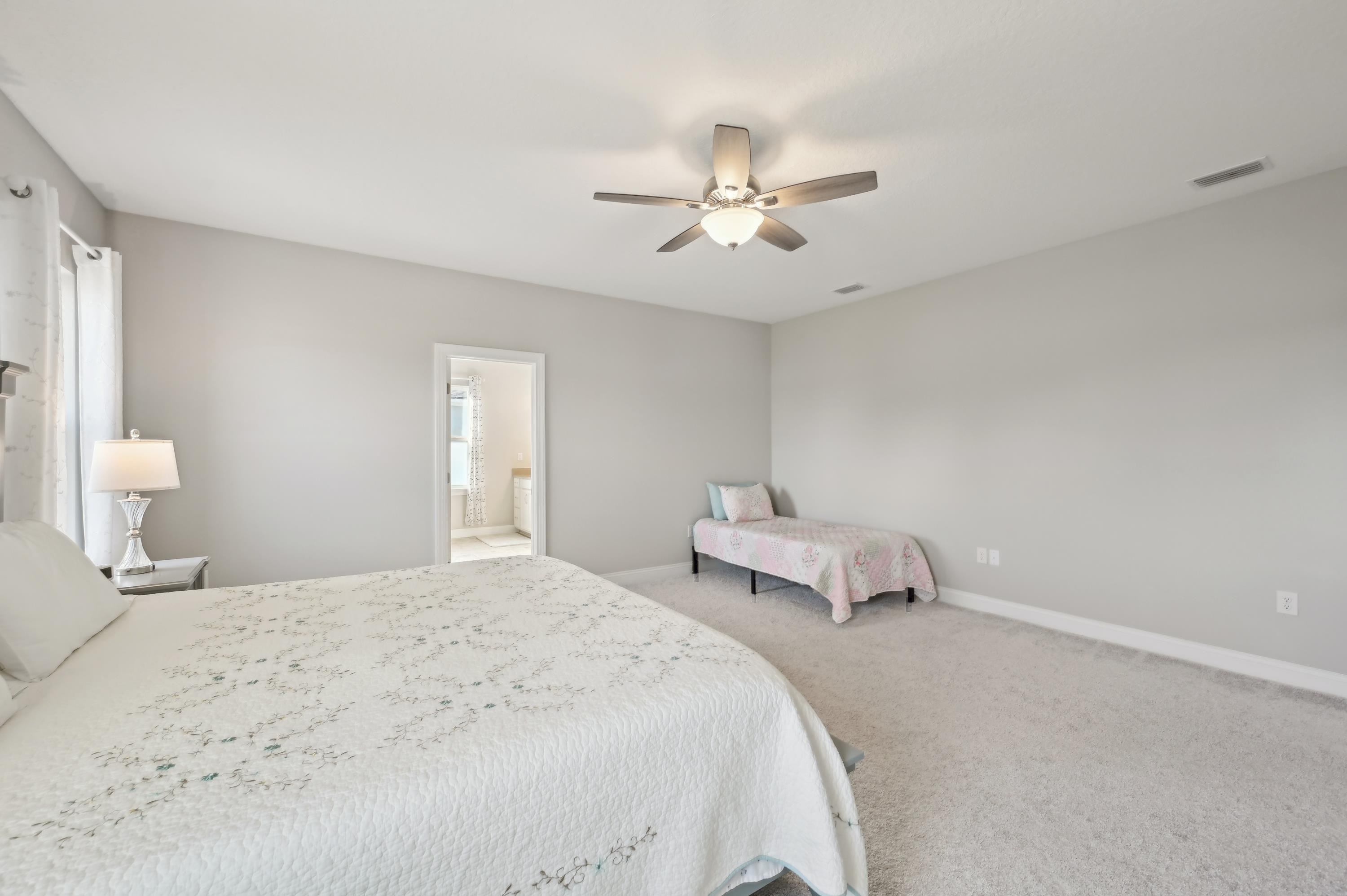 57 Sunset Ridge Court St. Johns, FL 32259 - Photo 46 of 79 a bedroom with a bed and a chandelier
