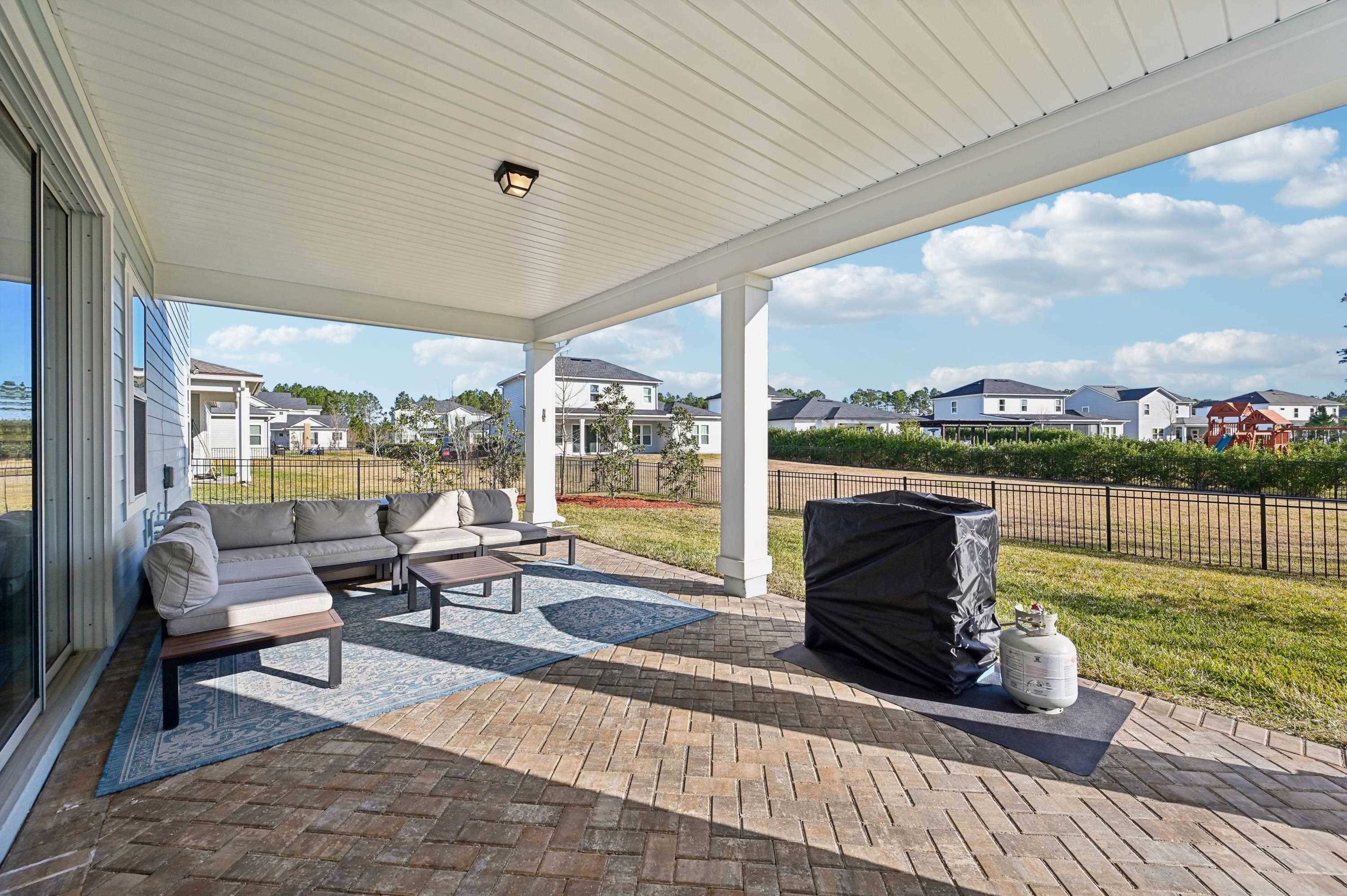 57 Sunset Ridge Court St. Johns, FL 32259 - Photo 56 of 79 a living room with patio furniture and a floor to ceiling window