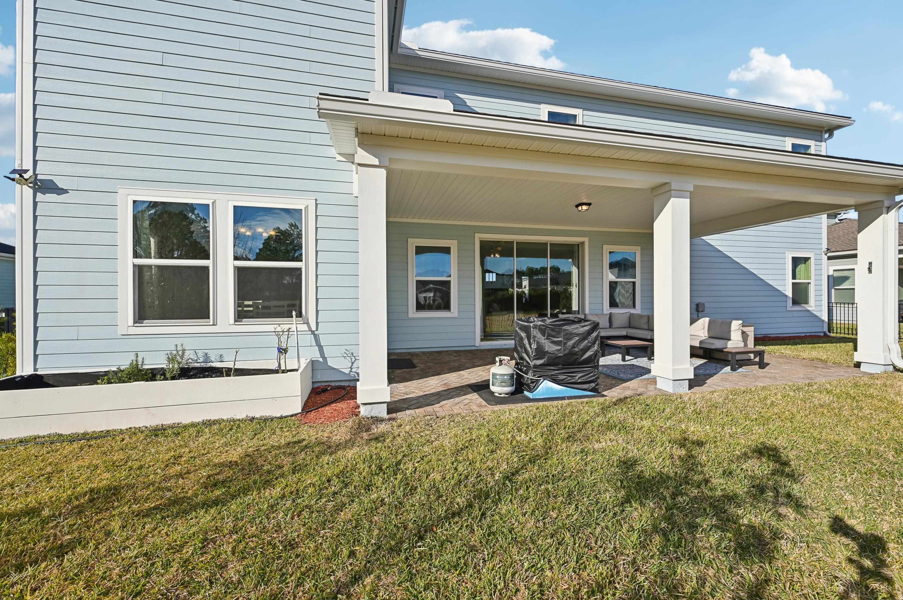 57 Sunset Ridge Court St. Johns, FL 32259 - Photo 58 of 79 Rear view of property featuring a yard, a patio, and an outdoor hangout area