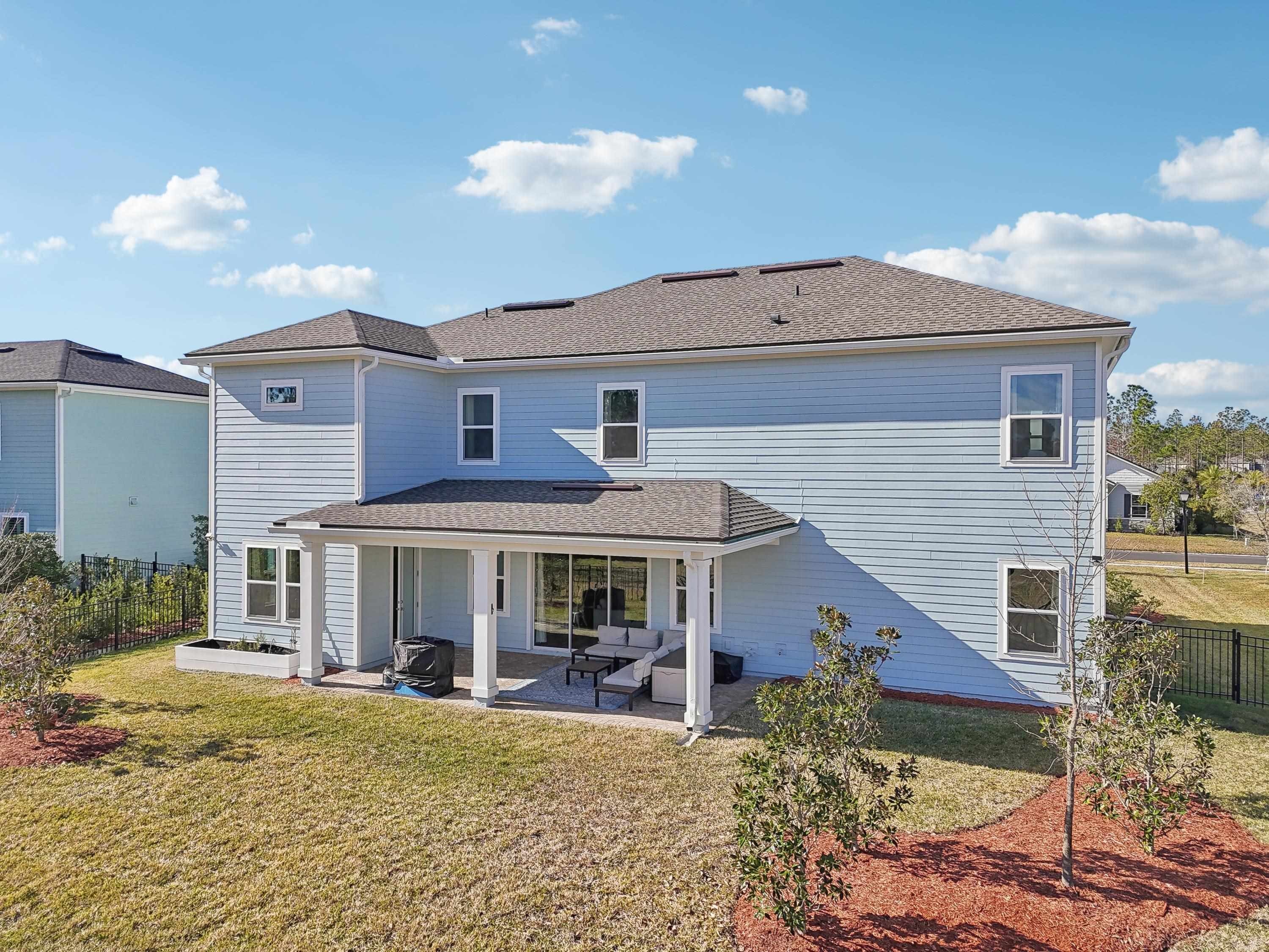 57 Sunset Ridge Court St. Johns, FL 32259 - Photo 70 of 79 Back of property featuring a patio area and roof with shingles