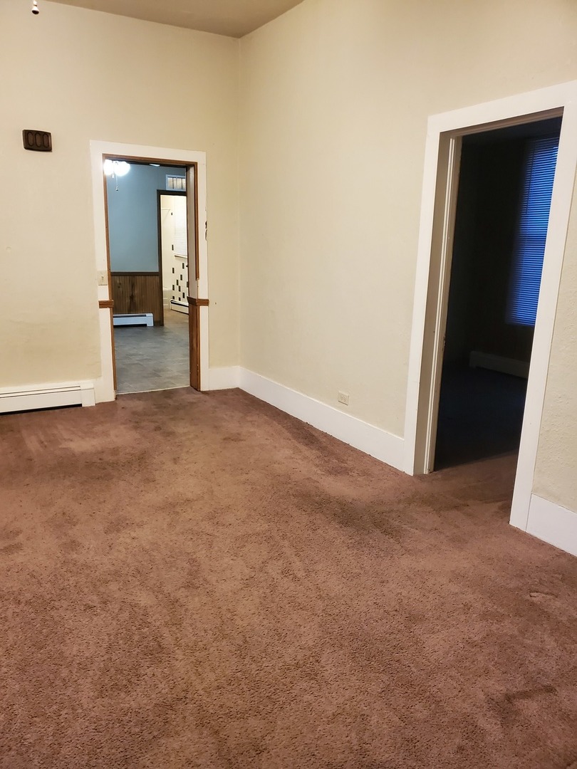 461 West Cermak Road Braidwood, IL 60408 - Photo 5 of 15 an empty room with an entrance and wooden door