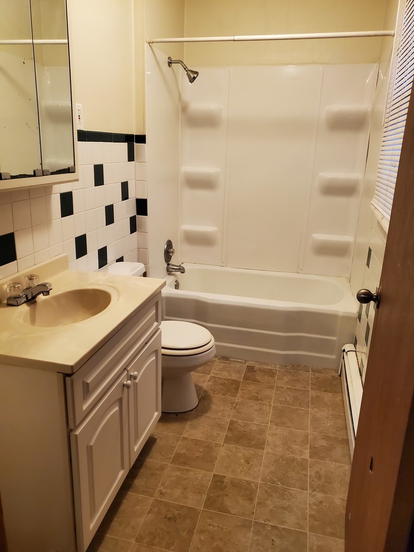 461 West Cermak Road Braidwood, IL 60408 - Photo 9 of 15 a bathroom with a sink a toilet and a bathtub