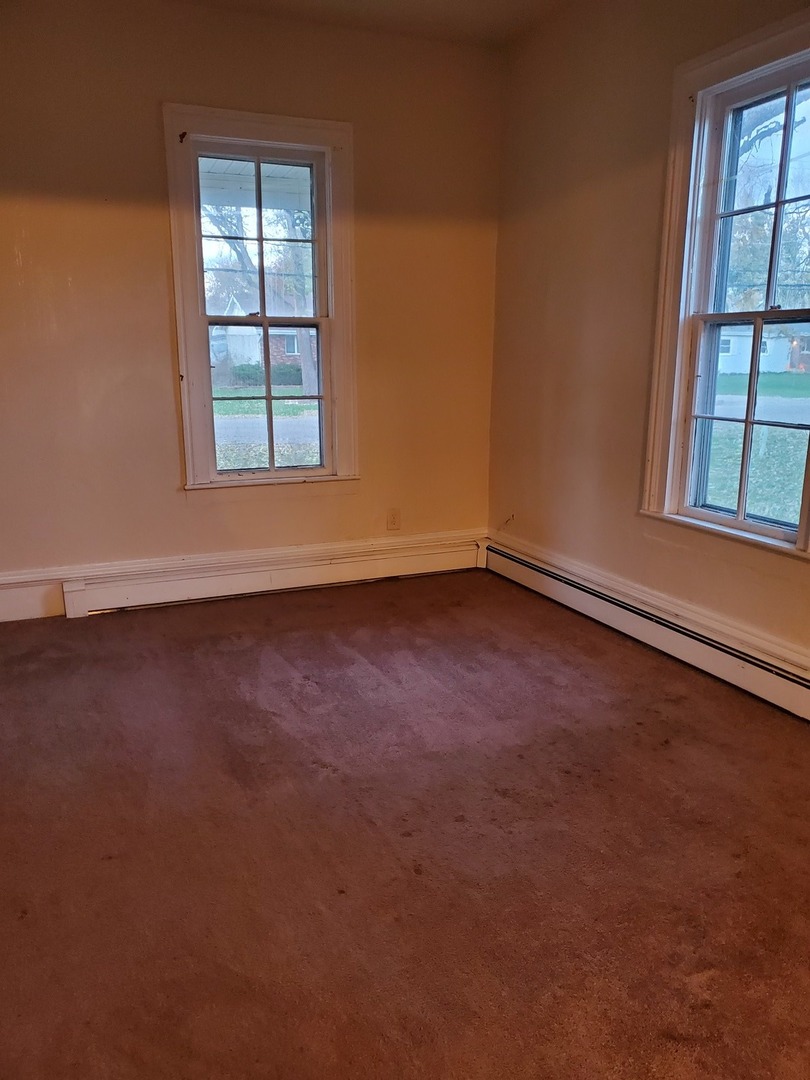 461 West Cermak Road Braidwood, IL 60408 - Photo 10 of 15 an empty room with wooden floor and windows