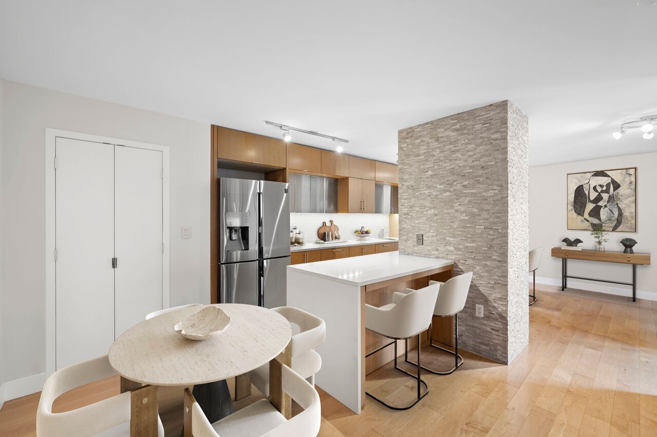 225 Rector Place, Unit 5K Manhattan, NY 10280 - Photo 6 of 12 a kitchen with stainless steel appliances a dining table and chairs