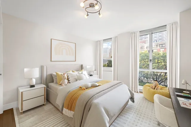 a bedroom with bed and a large window