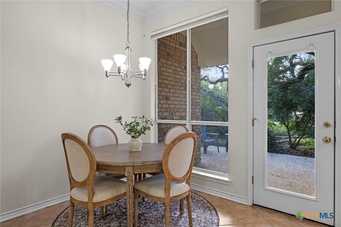 707 Livingston Court Temple, TX 76502 - Photo 13 of 36 a view of a dining room with furniture wooden floor and chandelier