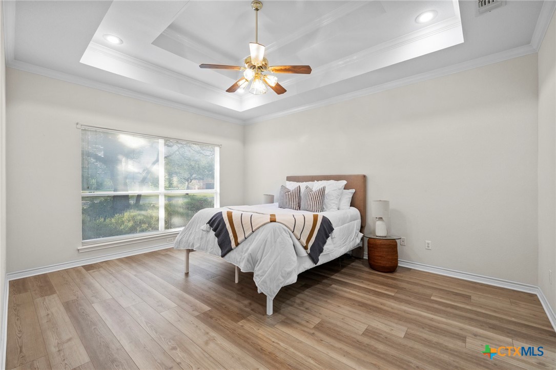 707 Livingston Court Temple, TX 76502 - Photo 17 of 36 a spacious bedroom with a bed and a large window