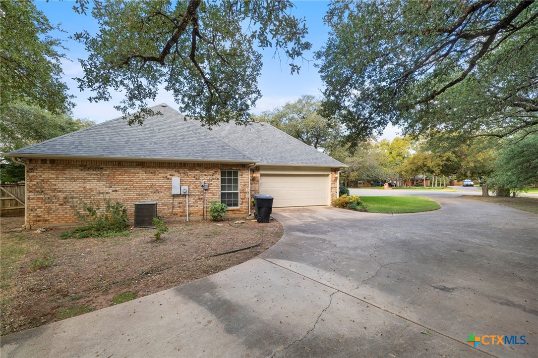 707 Livingston Court Temple, TX 76502 - Photo 35 of 36 a view of a house with a yard and garage