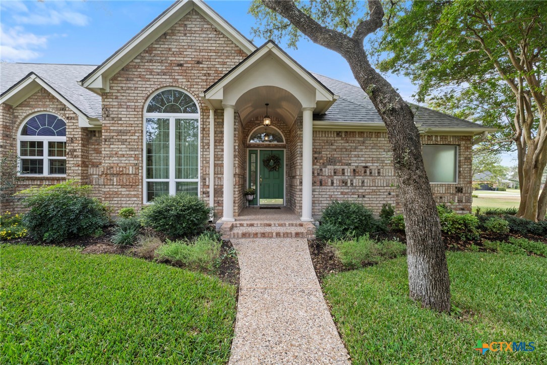 707 Livingston Court Temple, TX 76502 - Photo 4 of 36 a view of a brick house with a large windows and a large tree