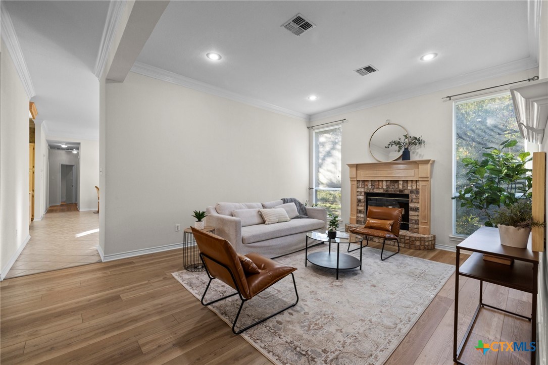 707 Livingston Court Temple, TX 76502 - Photo 6 of 36 a living room with furniture a fireplace and a large window