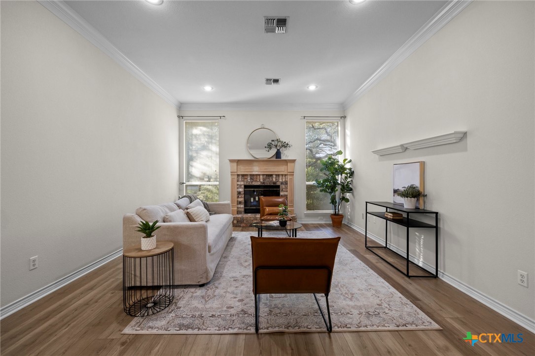 707 Livingston Court Temple, TX 76502 - Photo 7 of 36 a living room with furniture and a fireplace