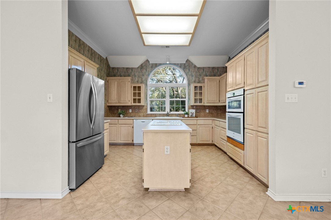 707 Livingston Court Temple, TX 76502 - Photo 10 of 36 a kitchen with stainless steel appliances granite countertop a refrigerator a stove a sink and a microwave
