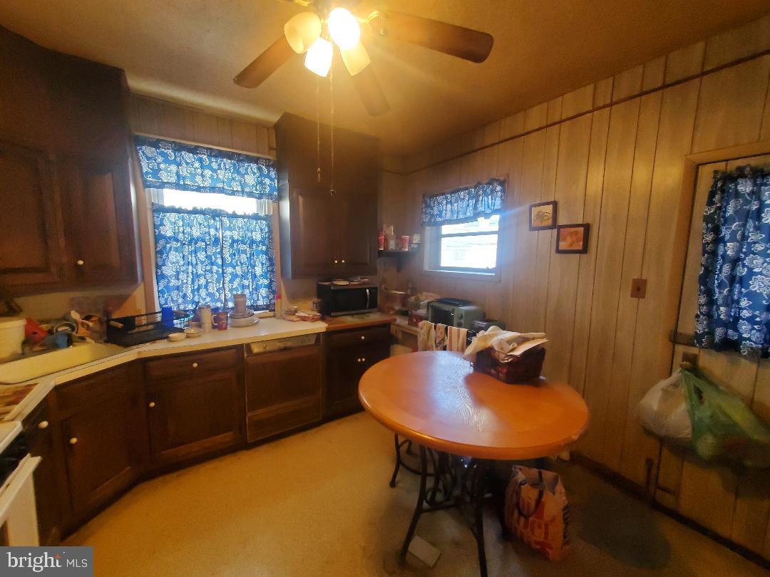 207 Avon Road Upper Darby, PA 19082 - Photo 11 of 29 a kitchen with a table chairs sink and cabinets