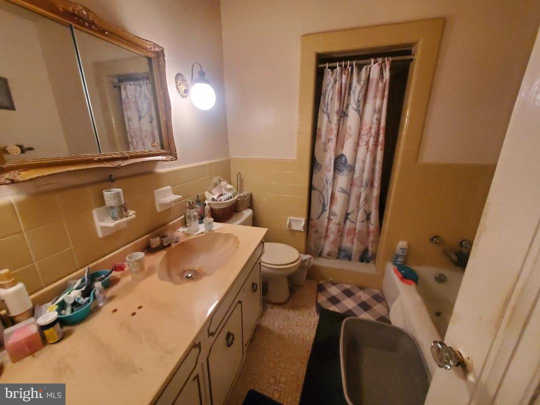 207 Avon Road Upper Darby, PA 19082 - Photo 18 of 29 a bathroom with a sink vanity and mirror